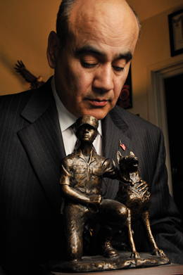 John Burnam Former war dog handler, John Burnam holds an award given to him at the 2007 Kennel Master (k9) Conference..