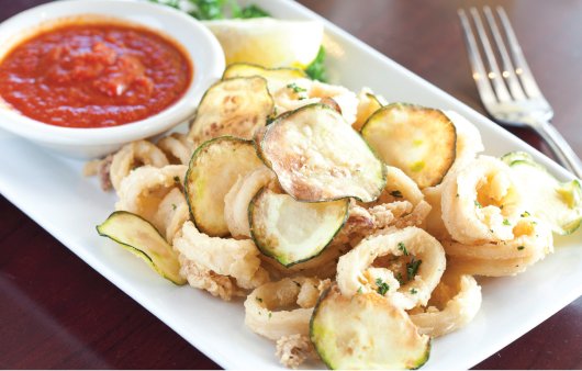 Thin slices of zucchini mingle with fried calamari. Thin slices of zucchini mingle with fried calamari.