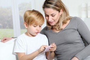 mother with child playing with an app