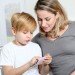 mother with child playing with an app