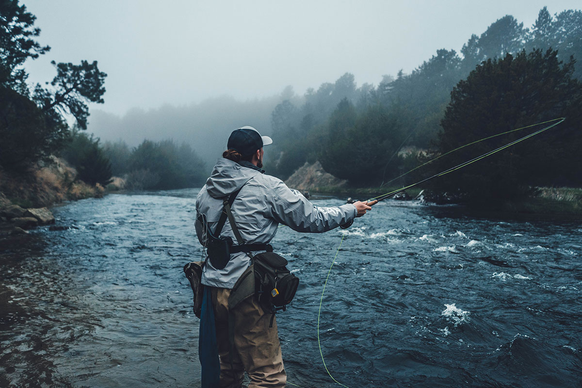 man fly fishing in water