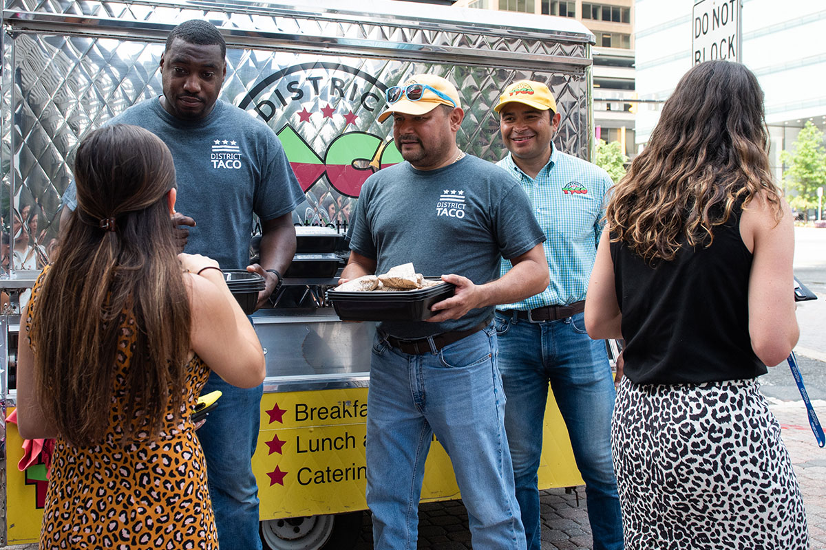 woman gets taco from food truck