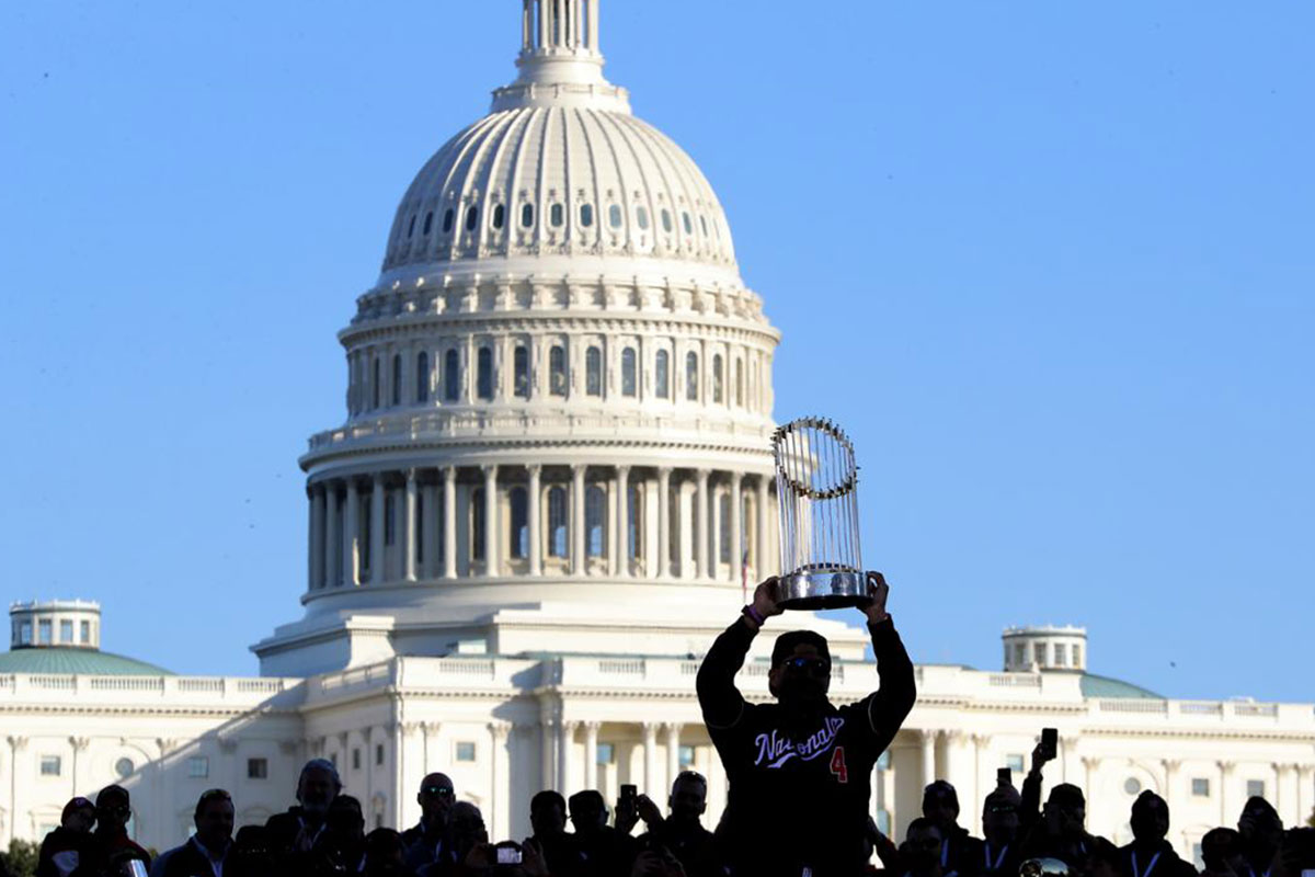 shadow of MLB champion trophy in front of capital building