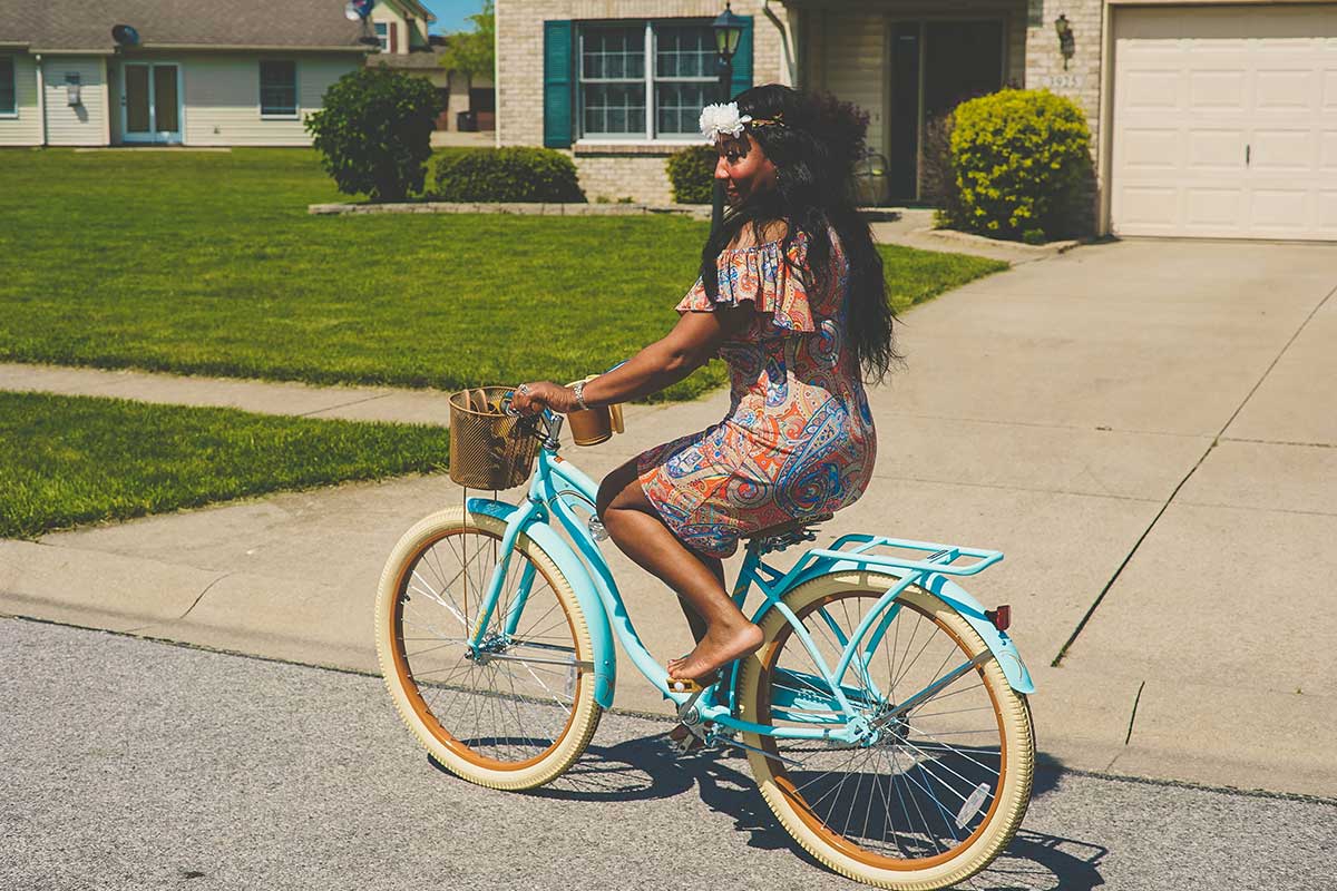 woman on bike with blue metal and yellow wheels