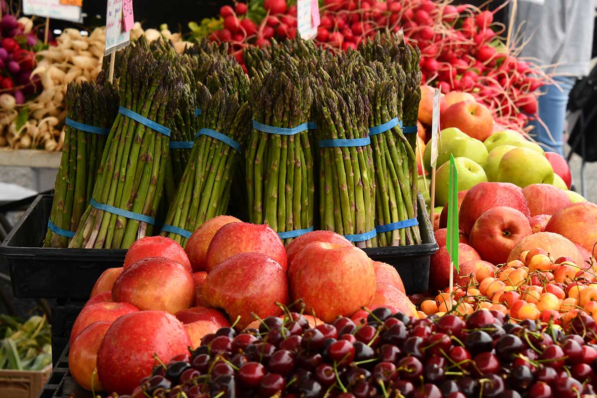 fresh produce with apples cherries and asparagus