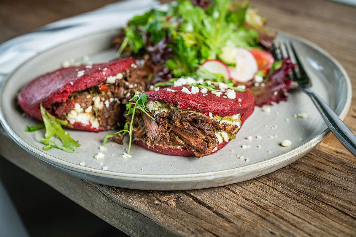 colorful arepas with meat inside on a plate